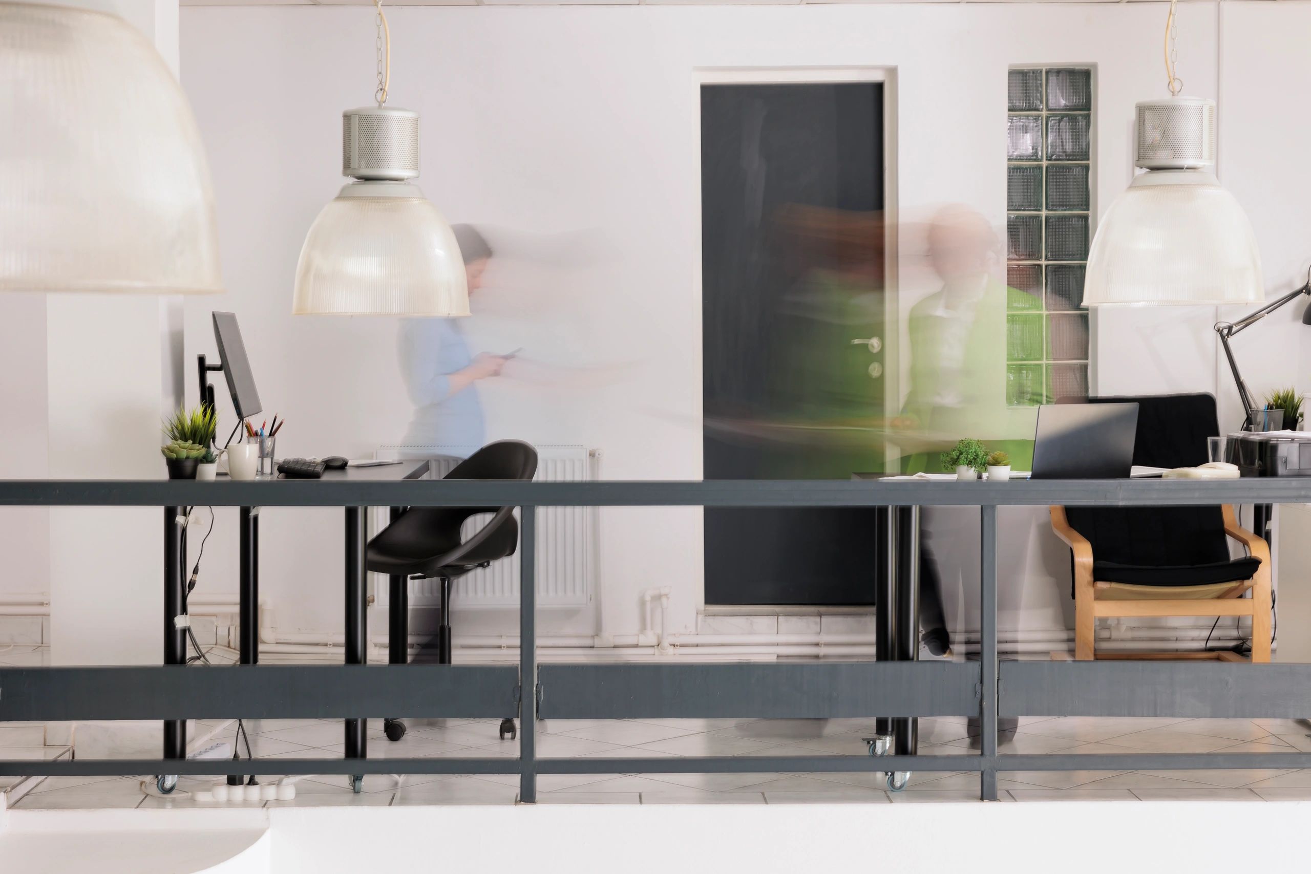 Modern office environment with employees moving through a professional workspace